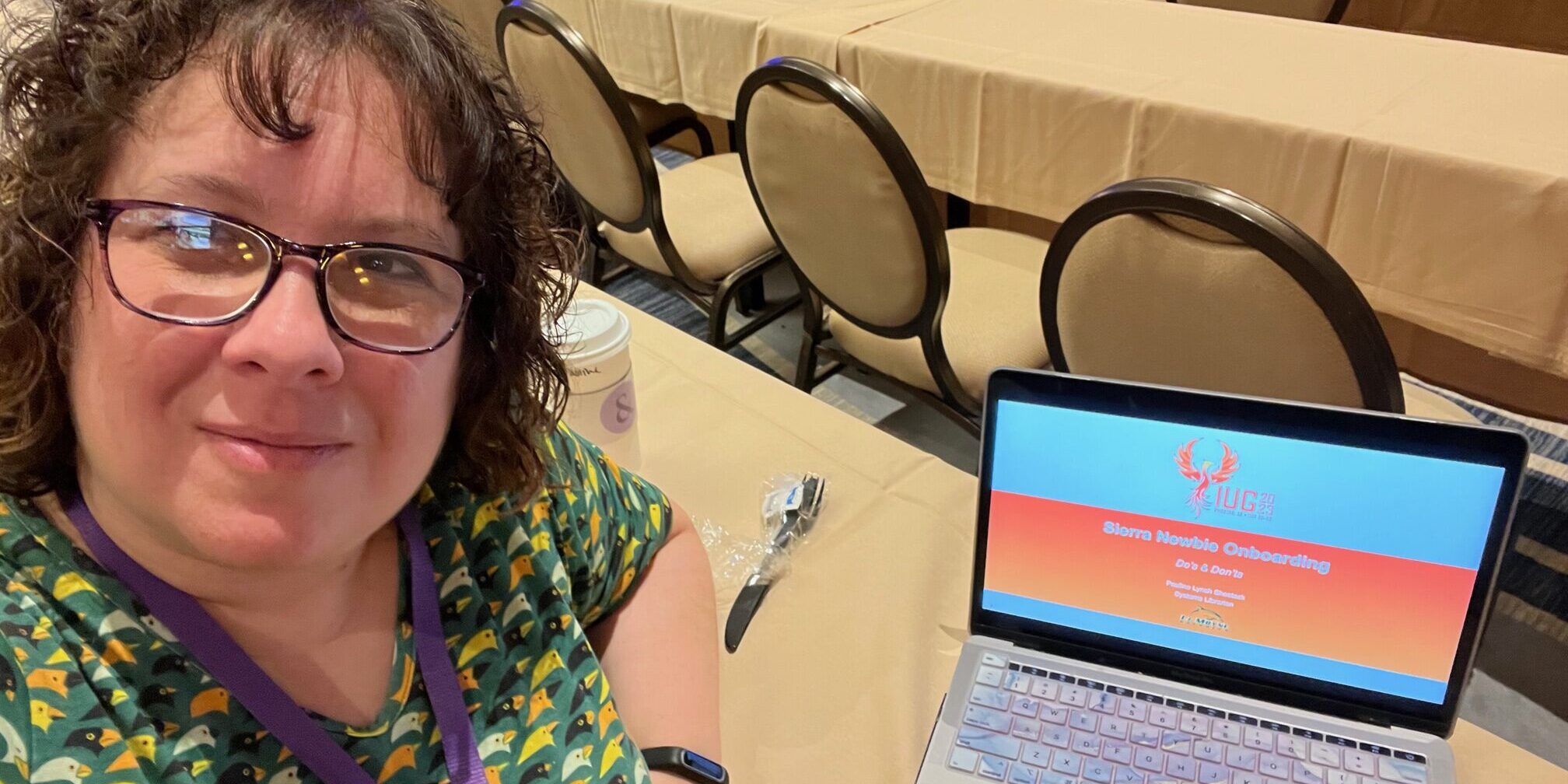 Pauline Lynch Shostack at the Innovative User Group Conference Pauline Lynch Shostack sitting at a table with a laptop.